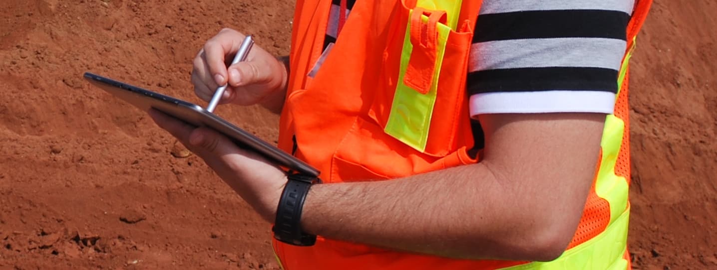 Photo of worker using application on tablet