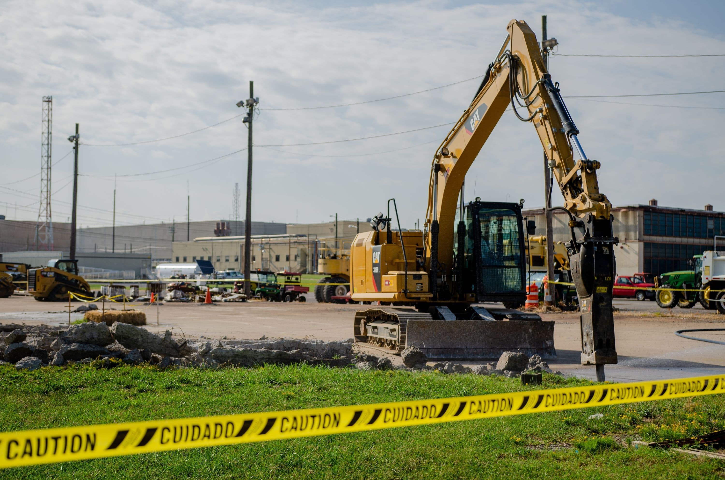 Workers use a jackhammer to break up concrete in the initial stage of construction on the Large Item Neutron Assay System facility