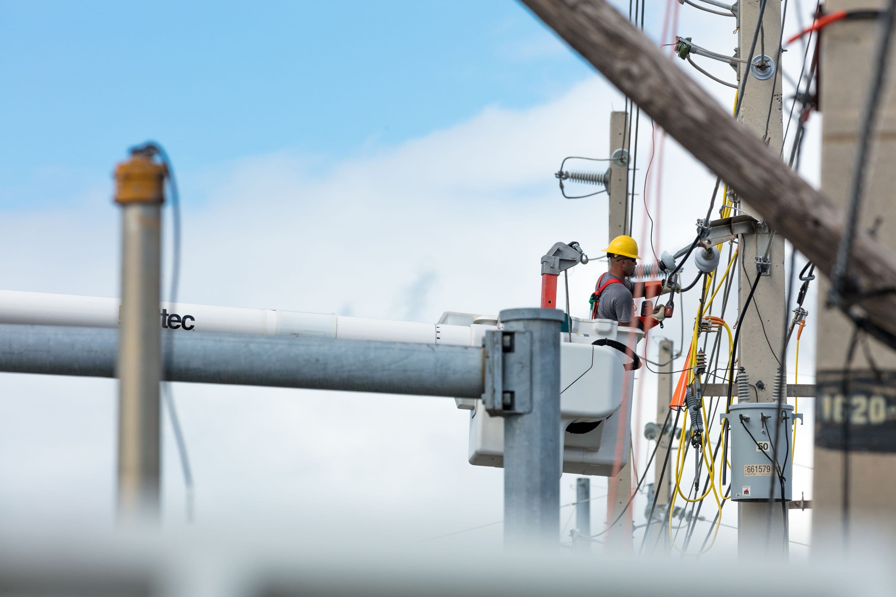 Crewman in lift working on restoring power in Puerto Rico