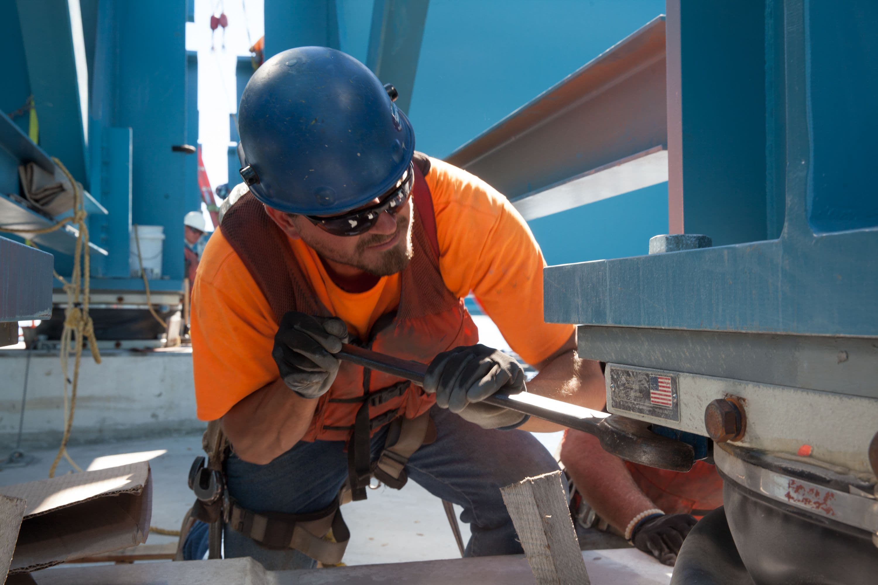 An ironworker helps connect the final westbound girder assembly.