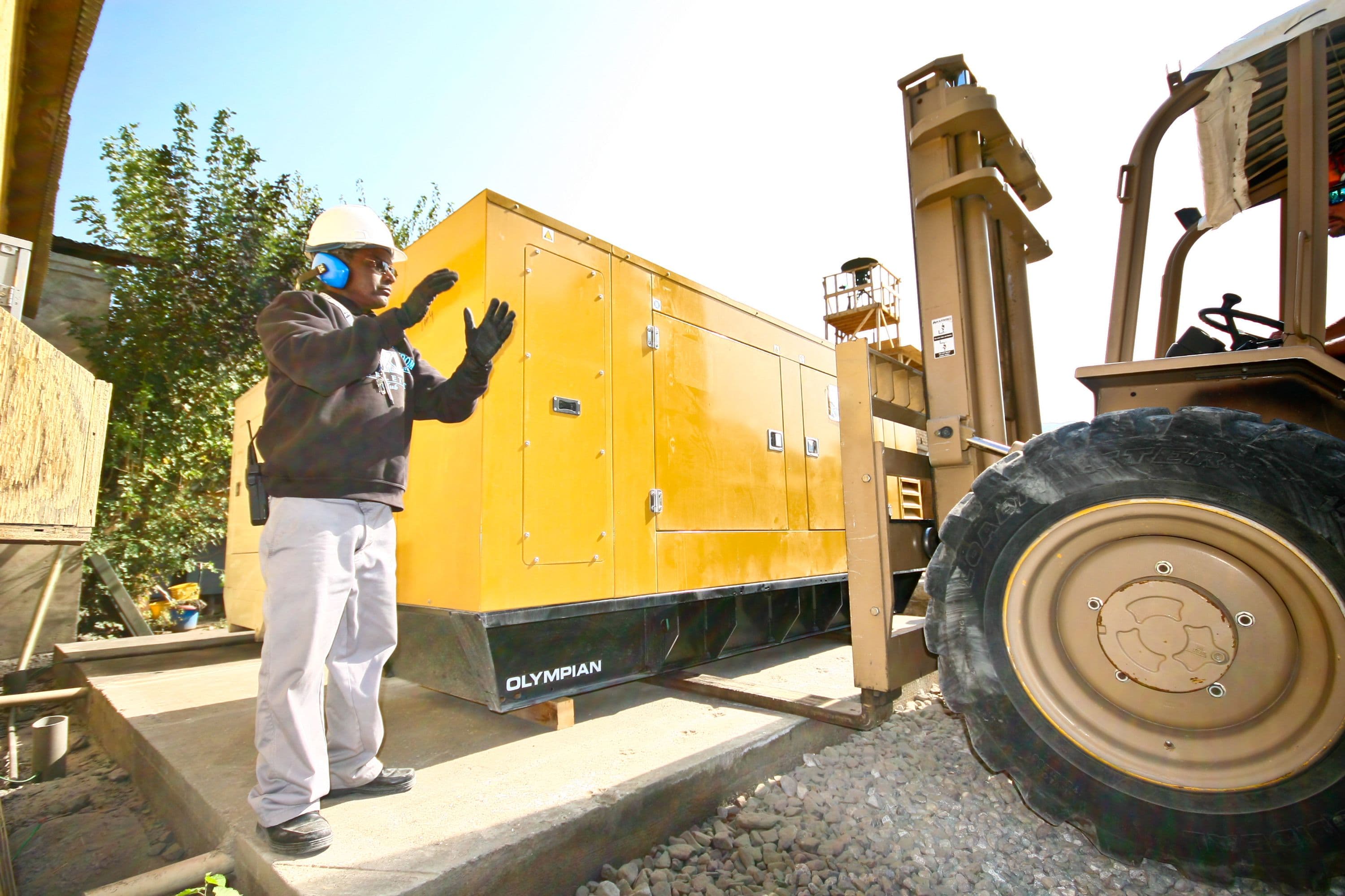 Employee directing forklift