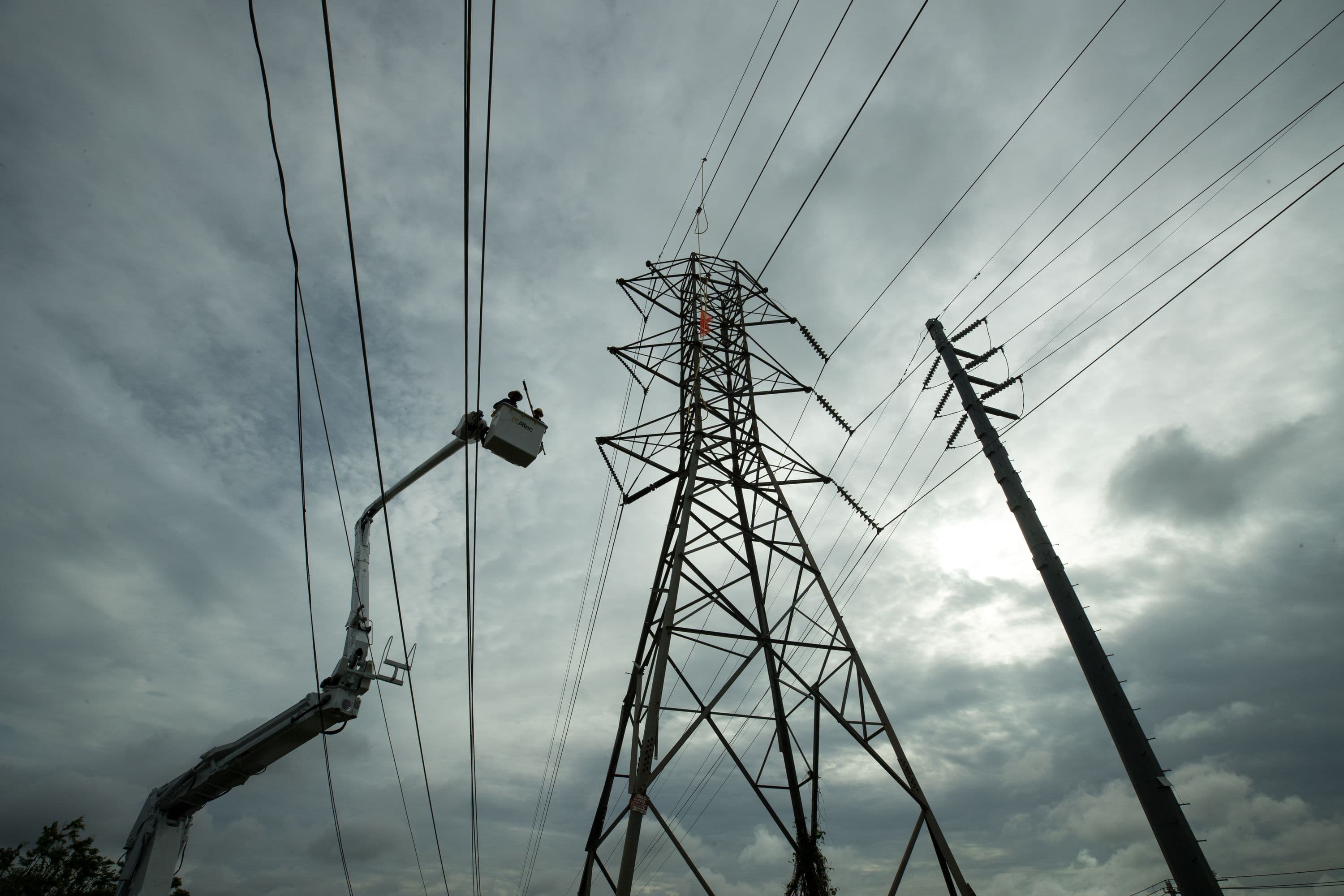 Transmission crew in lift working to restore power