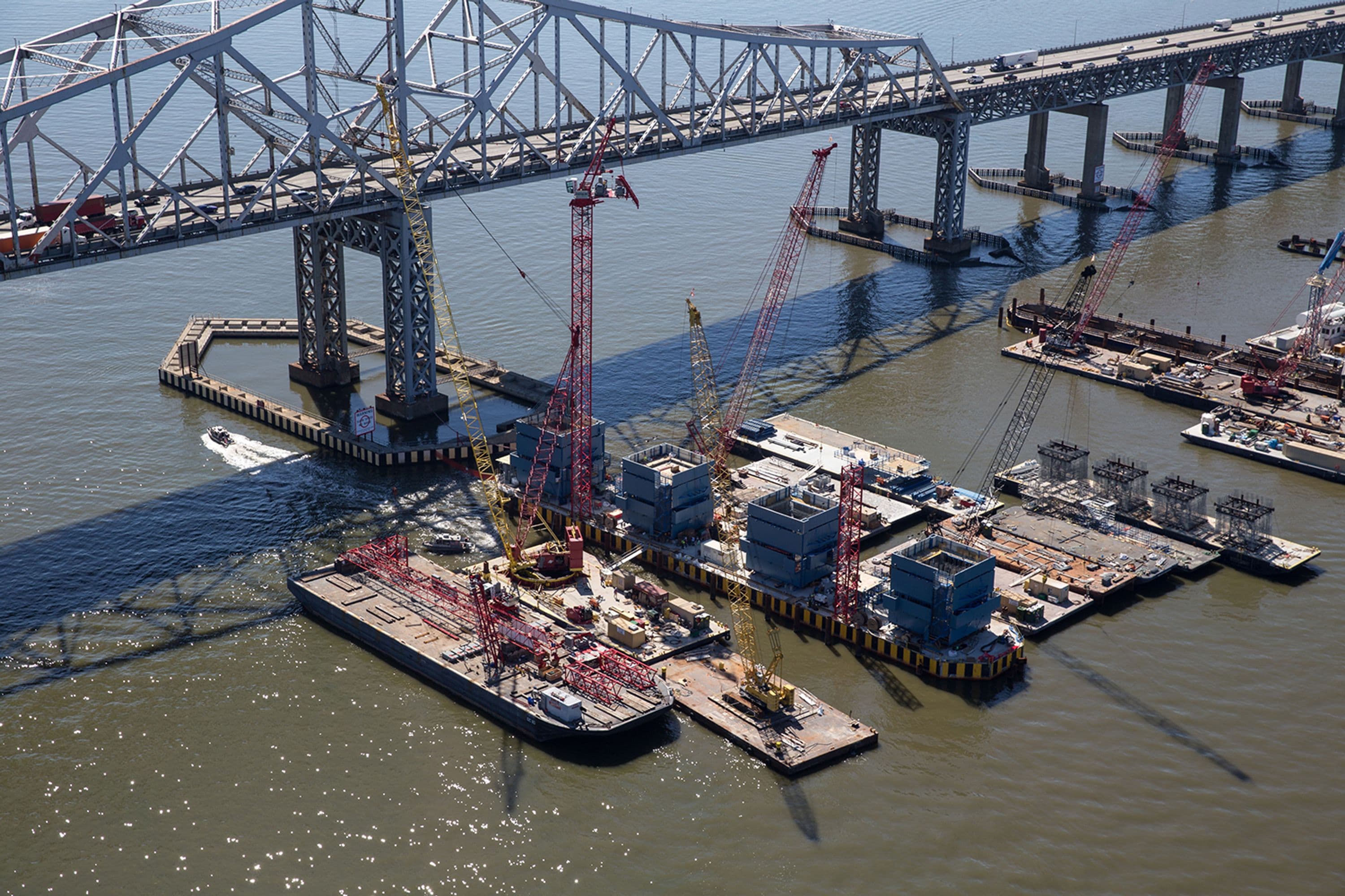 The new bridge's 419-foot towers begin construction on football-field-length foundations.