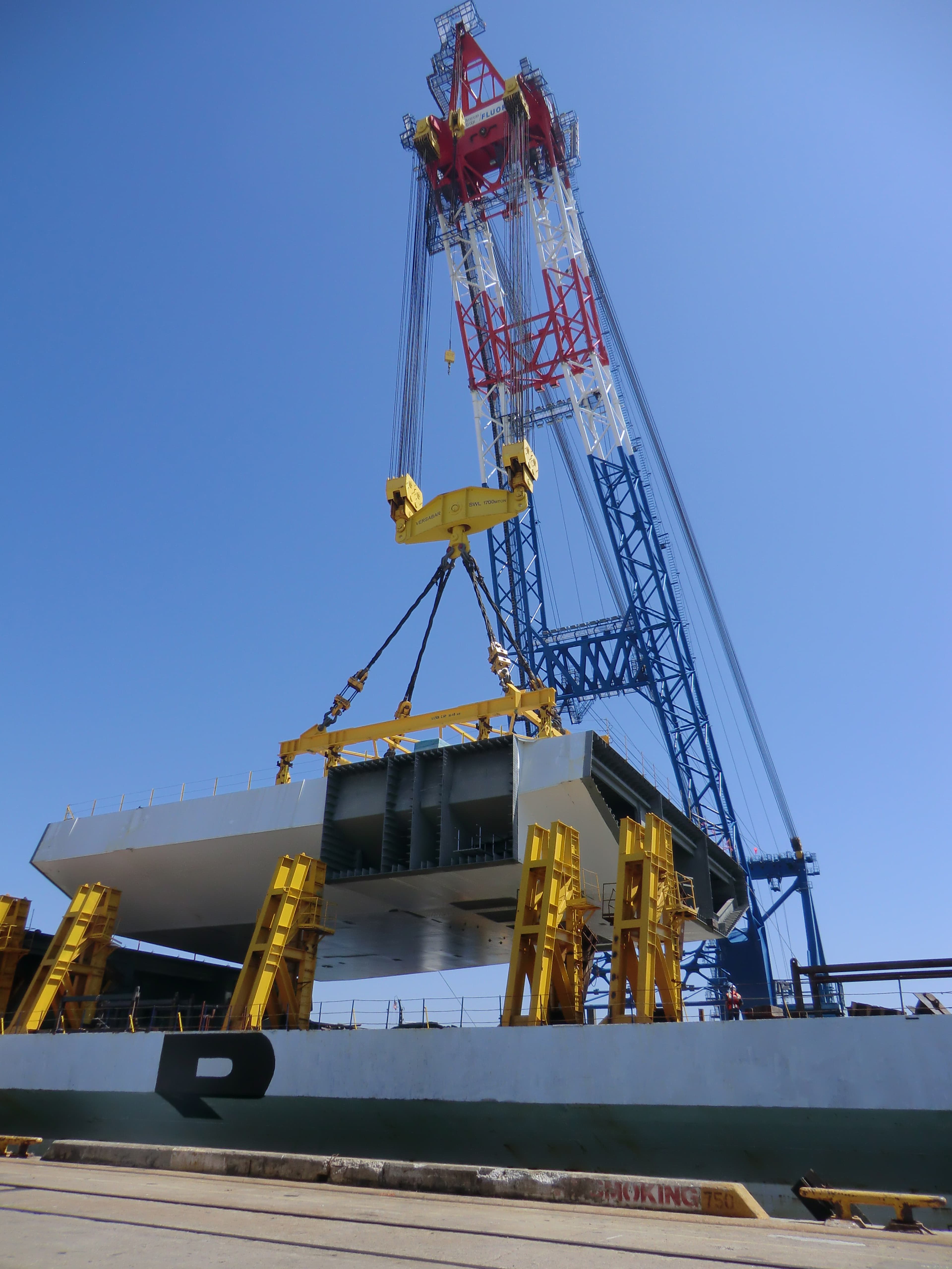 Photo of crane holding module from bridge project