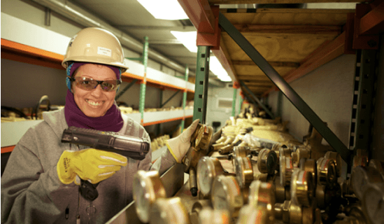 Woman with hard hat scanning inventory